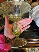 Full view of Murano vaseline glass candy dish held in hand