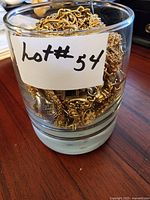 Jar filled with tangled gold and silver-tone chains