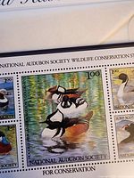 Close-up of 1985 stamp sheet featuring Hooded Mergansers and companion bird images