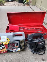 All items grouped: toolbox, pump, drill bit kit, power strip visible