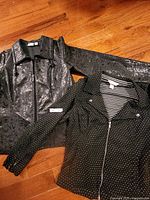 Two jackets laid flat showing full fronts
