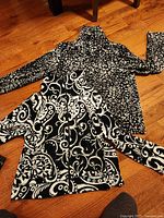 Both jackets laid flat showing front patterns and zippers