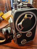 Side view of Bolex camera showing controls and Kodak film box beside it