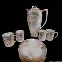 Full view of chocolate pot, cups and saucers showing design and count