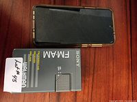Front of Samsung smartphone and front of Sony Walkman FM/AM radio