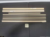 All balsa wood pieces laid out on black surface