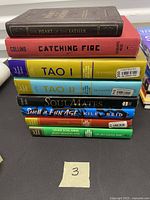 Stack of eight titled books showing spines