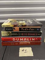 Stack of five fiction paperbacks showing spines and titles