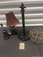 Group shot of two lamps, iron towel holder, metal sphere