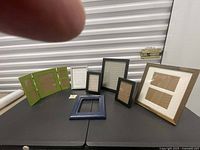 Group shot of seven assorted frames on table