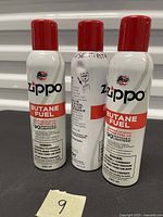 Front and side views of three Zippo Butane Fuel cans