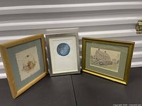 All three framed artworks standing side by side