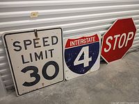 Three traffic signs standing side by side