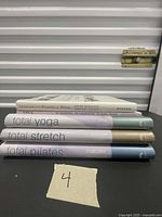 Stack of five exercise books on black surface