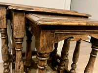Close-up of two tables showing turned legs, oak grain, mortise and tenon joints