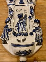 Front view of Delftware holy water font showing Magi figures, basin, and painted details