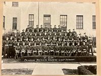 Full view of mounted group photograph showing soldiers and inscription