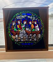 Front view of stained glass panel showing full design within wood frame