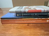 Four books stacked showing spines