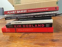 Stack of six art books with visible titles on spines