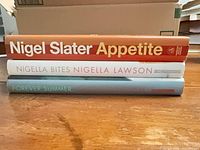 Three cookbooks stacked showing spines