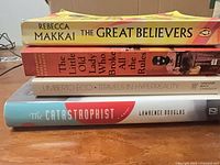 Stack of all four books showing spines and titles