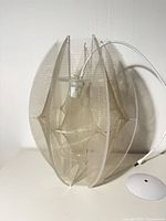 front view of plexiglass string lamp showing overall shape and cord