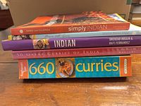 Stack of five Indian cookbooks