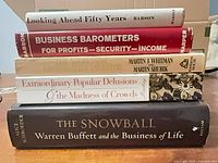 Stack of five investment books showing spines