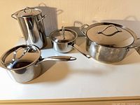 Group shot of all four Lagostina stainless pots with lids