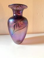 Front view of purple iridescent glass vase
