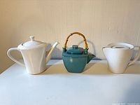 group shot of three teapots front view