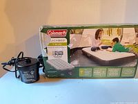 Coleman QuickBed box front with included pump shown