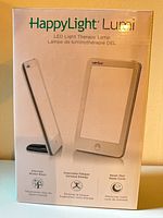 Front of original box showing Verilux HappyLight Lumi lamp image and branding