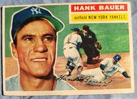 Front of 1956 Topps Hank Bauer card showing portrait, action scene and name banner