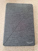 Grey fabric folio cover closed, Amazon smile logo visible