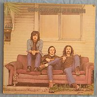 Front cover of Crosby, Stills & Nash LP showing trio on sofa, Atlantic logo top left