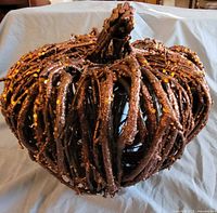 Front view of twig pumpkin showing twig construction and glitter accents