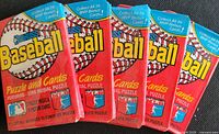 Five sealed red 1988 Donruss baseball wax packs displayed side by side