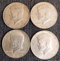 Obverse views of four Kennedy half dollars dated 1966-1969