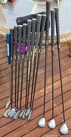 Clubs lined up showing full length, grips, shafts and heads