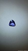Front view of pear-cut violet-blue tanzanite gemstone