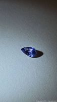 Pear-shaped faceted tanzanite viewed from table side