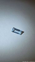 Front angled view of rectangular light blue baguette-cut aquamarine