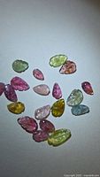 Group of multicolored leaf-cut tourmalines on white background
