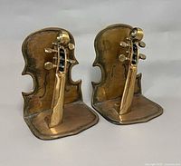 Front three-quarter view of both brass violin bookends