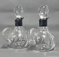 Front view of both cruets showing collars, handles and cut pattern