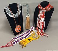 Group shot of all seven Huichol bead items on display stands and flat