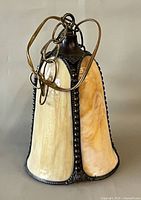 Pendant light front view showing slag glass and metal frame