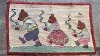 Full view of hooked rug showing three bears design, red border